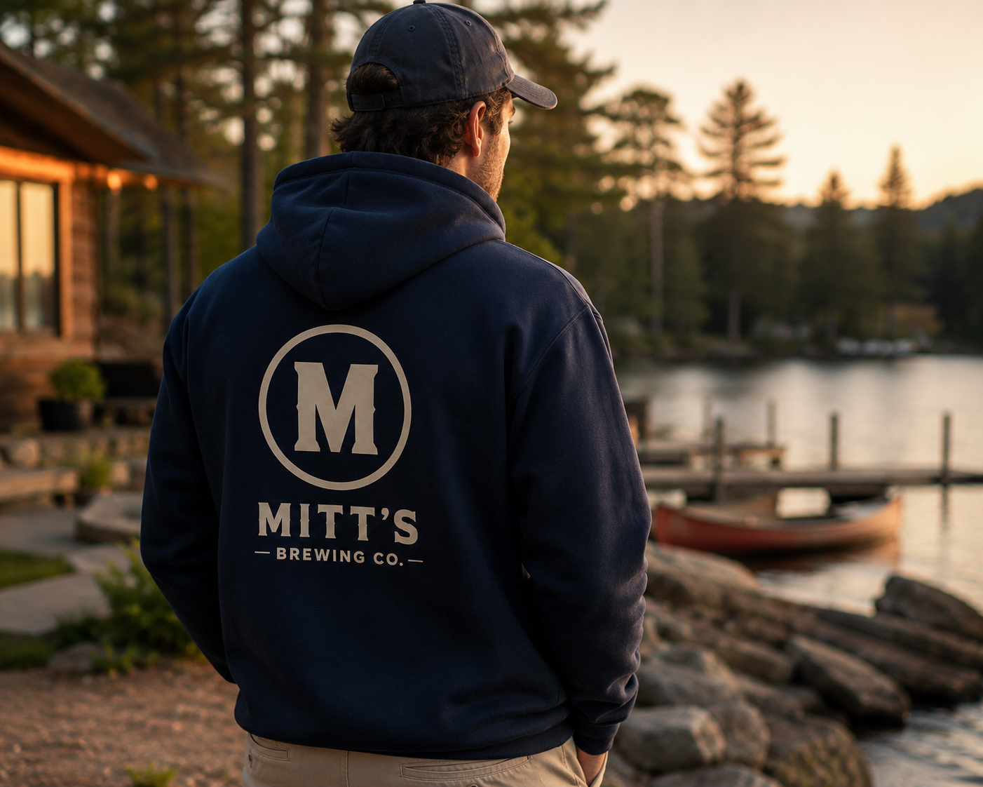 Navy Mitt's Brewing hoodie worn beside a Canadian lake